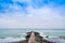 Concrete pier or jetty on seascape with cloudy blue sky in Levanto, Italy