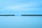 Concrete pier and stairs in a cloudy and blue ocean