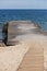 Concrete pier, wooden walkway sand and sea