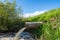 Concrete pipe transporting the polluted sewage water in to a small pond