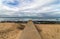 Concrete Pipeline Extending onto Beach and Rocky Coastal Seasc