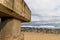 Concrete Pipeline Extending onto Beach and Rocky Coastal Seasc