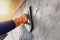 Concrete plasterers to create industrial workers background walls with plastering tools