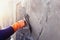 Concrete plasterers to create industrial workers background walls with plastering tools