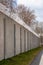 Concrete prison wall with surveillance camera