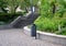 Concrete retaining wall at the large staircase in the park the flowerbed area is planted with rich greenery of perennials granite