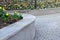 Concrete retaining wall at the large staircase in the park the flowerbed area is planted with rich greenery of perennials granite