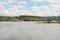 Concrete road bridge on the highway over the river in western Germany, visible flowing cargo barge, in the background blue sky and