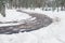 concrete road in snowy winter forest