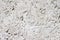 Concrete with rocks wall bumpy grey painted surface for cool urban grungy wallpaper or macro background