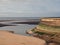 Concrete seawall of the old boating pool at blackpool lancashire surrounded by pools of water on the beach at low tide with a