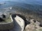 Concrete staircase down to the sea . Spiral stairs descent to the water . Tuscany, Italy