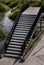 Concrete staircase and floor with iron railing lead up from footpath