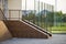 Concrete stairs covered with ceramic tiles with metal railings outdoors