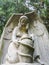Concrete statue of an angel with a jug in the park