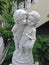 A concrete statue of a young boy kissing a girl on the cheek.