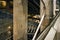 Concrete & steel walls and tubes in Westminster underground train station, blurred people walking down stairs in distance -