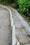 Concrete step flow for the flow of rainwater along a very steep asphalt walkway running down the hill