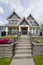 Concrete steps leading to residential house entrance over front yard. Luxury house built on land terrace