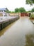 Concrete street in House water flooding in rainy day. dirty water unclean near high raised soil ground. no people