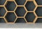 Concrete table with wooden hexagons shelf background, 3D rendering