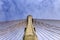 Concrete tower and cable bridge with cloud and blue sky