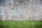 Concrete wall and green grass floor texture