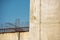 Concrete wall with metal studs against the sky, soft focus