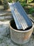 Concrete wall with zinc sheet on top to collect rain water at the farm