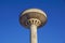 Concrete water tower against blue sky