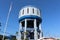 The concrete water tower tank under blue sky and white cloud for water supply