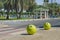 Concrete yellow restrictive spheres with funny smiley face indicating entry to pedestrian zone and park