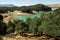 Conde de Guadalhorce Reservoir and its turquoise wat  with trees in Malaga, Andalusia, Spain