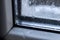 Condensate drops on the glass of a plastic window. Freezing and the formation of condensation and mold on the new