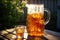 condensation on a glass pitcher filled with iced tea outdoors