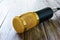 Condenser gold microphone on a wooden table. The light from left side.