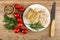 Condiment, tomato, dill, piece, slices of pork salted lard in plate, knife on wooden table. Top view