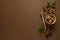 Condiments and spices, honey spoon, anise star, cinnamon sticks, mint leaves, brown background top view