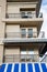 Condo Balconies Over Blue and White Awning