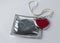 Condom with chain and heart