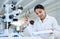 Conducting some lab-based research. a young scientist going through paperwork in a lab.