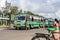 Conductor of green inter-city state transport bus waits for passenger near door