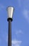 A cone-shaped lamppost against blue summer sky