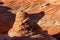 Cone shaped tower of layered sandstone in the Arizona desert of the Kaibab Plateau