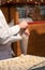 Confectionary baker preparing a fresh batch of delicious sweet coconut macaroon cookies