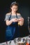 Confectioner cracking an egg into steel dish