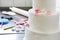 Confectioner decorates wedding cake in bakery