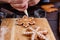 Confectioner decorating gingerbread cookies with confectionery i