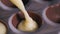 Confectioner filling milk chocolate mould from the piping bag. Macro