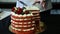 Confectioner hands cut in pieces red decorated cake